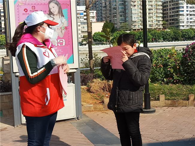 志愿者对群众发放《致广大居民的一封信》.jpg
